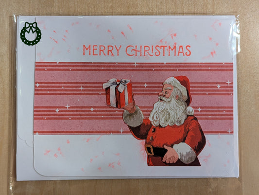 Christmas card with Santa Claus holding a gift on a red and white striped background.