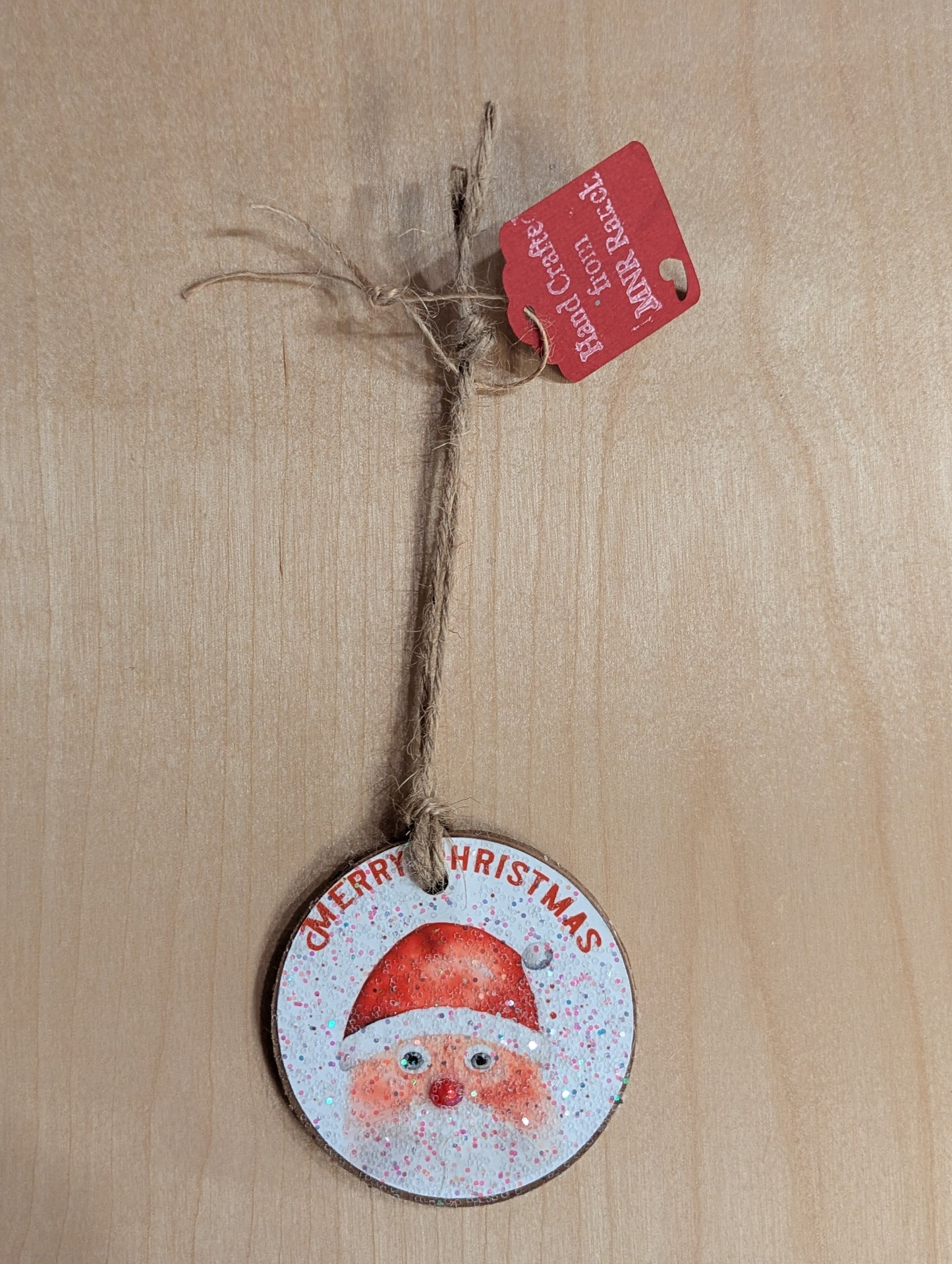 A Santa Claus ornament saying 'Merry Christmas'