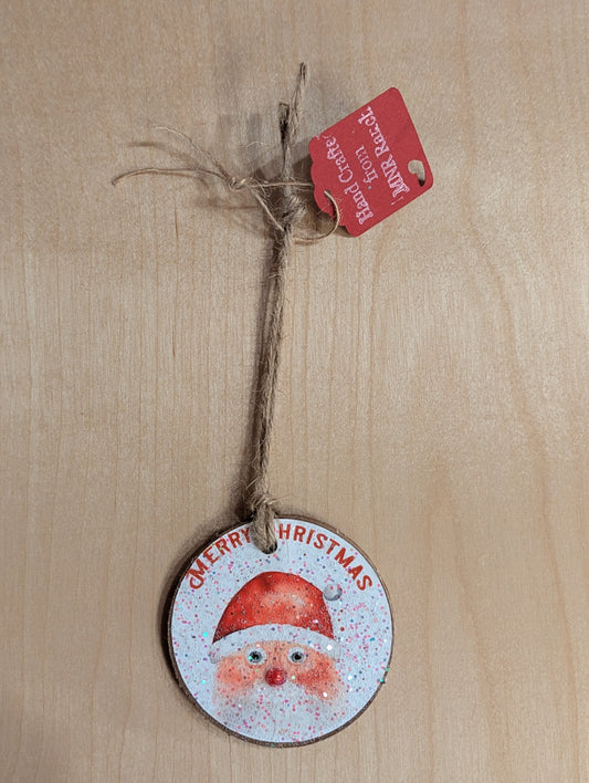 A Santa Claus ornament saying 'Merry Christmas'