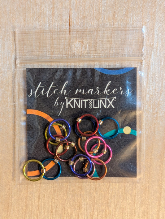 Knitting or crocheting stitch markers by KnitLinx for knitting needle size 0 through 8 made from metal in assorted colors.