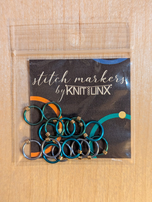 Knitting or crocheting stitch markers by KnitLinx for knitting needles size 0 though 8. Made from metal in silver and teal blue