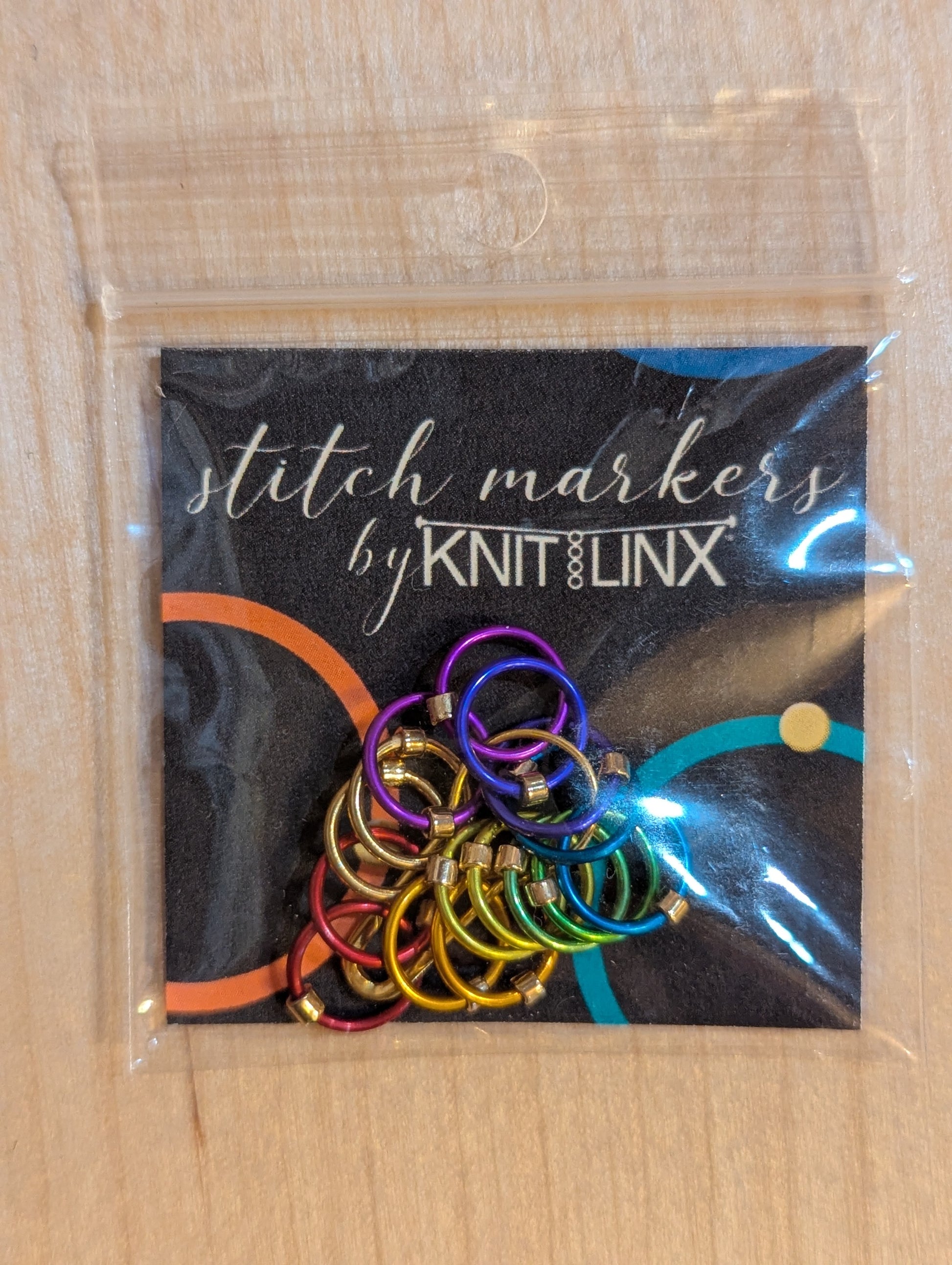 Knitting and crochet stitch markers by KnitLinx for knitting needles sizes 0 through 9. Made from metal in rainbow colors.