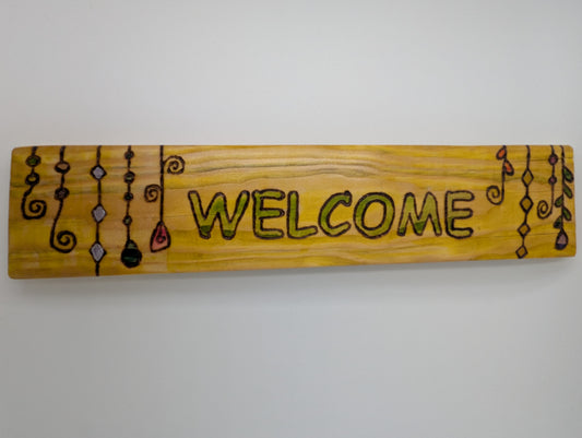 Wood-burned and hand painted wooden sign with 'WELCOME' text and decorative suncatchers.