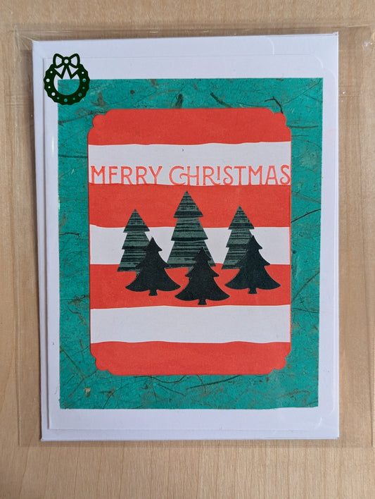 Christmas card with red and green design featuring trees and 'Merry Christmas'