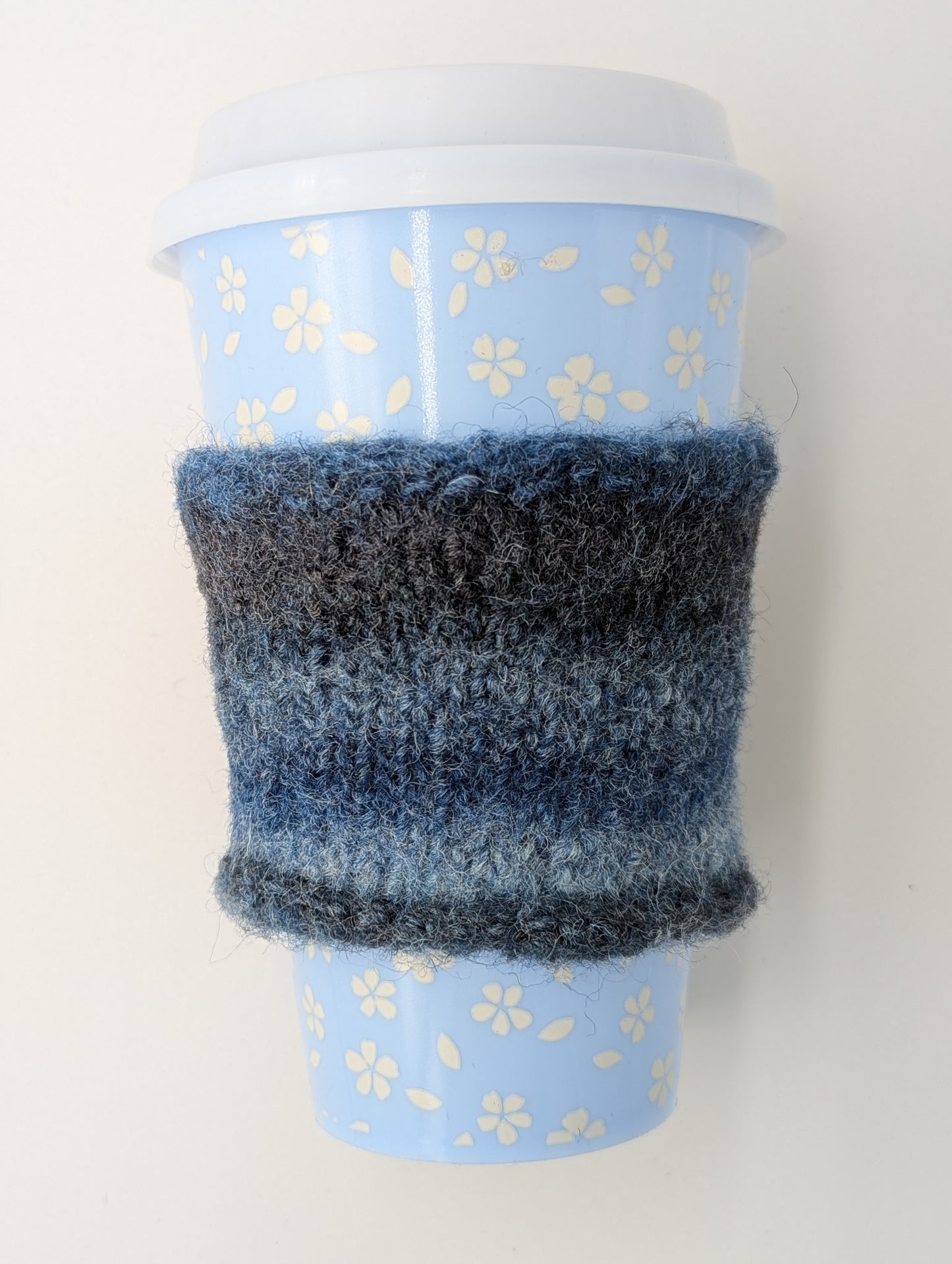 Knitted and felted blue and gray color gradient mug cozy