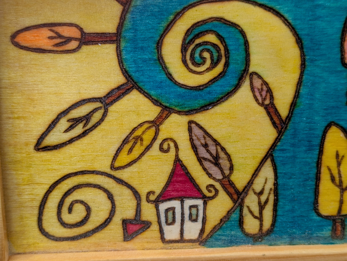 Colorful illustration of a sun with feathers and a small house on a wooden box