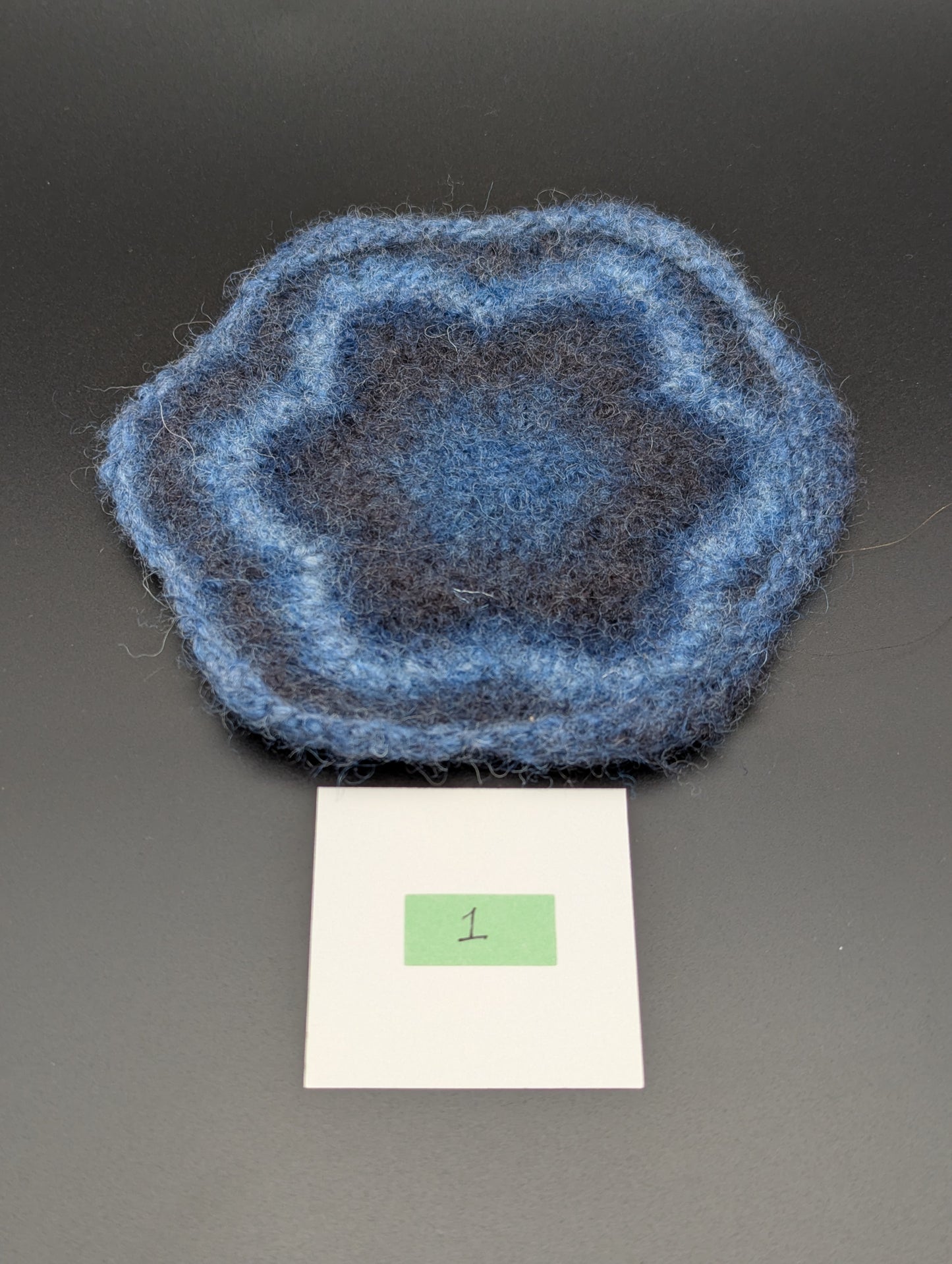 Blue hand knitted and felted coaster. This coaster is number 1.