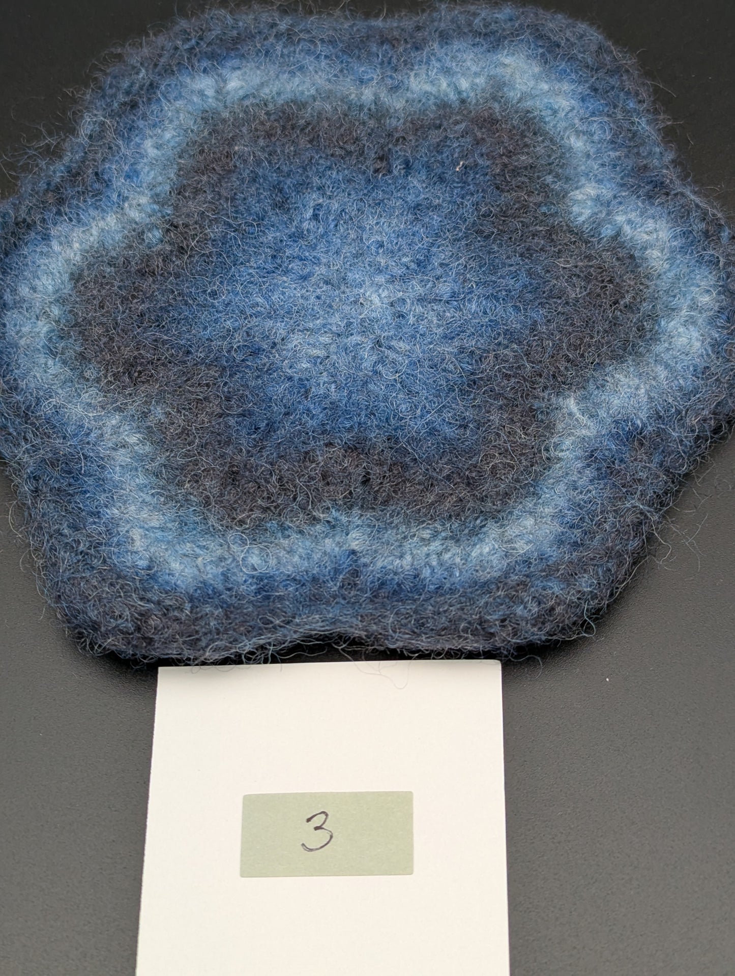Blue hand knitted and felted coaster. This coaster is number 3.