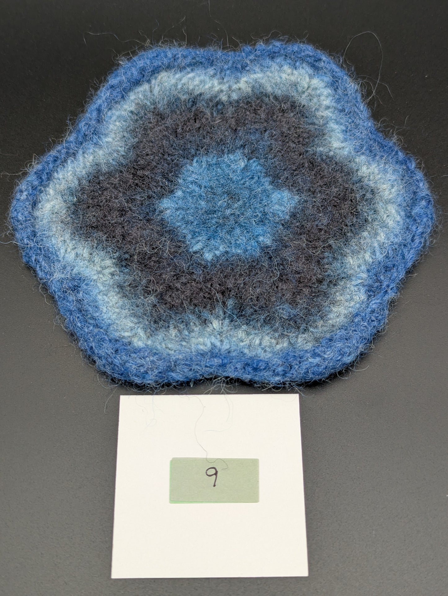Blue hand knitted and felted coaster. This coaster is number 9.