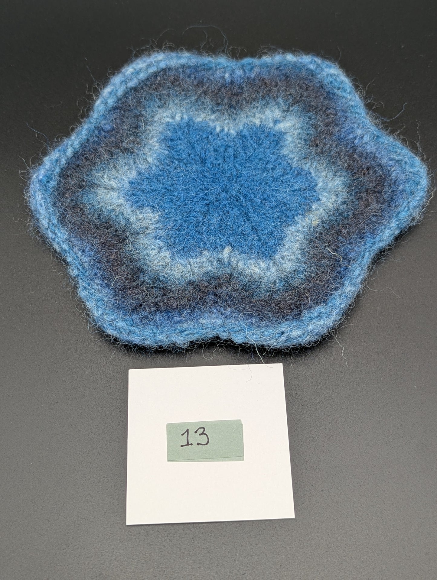 Blue hand knitted and felted coaster. This coaster is number 13.