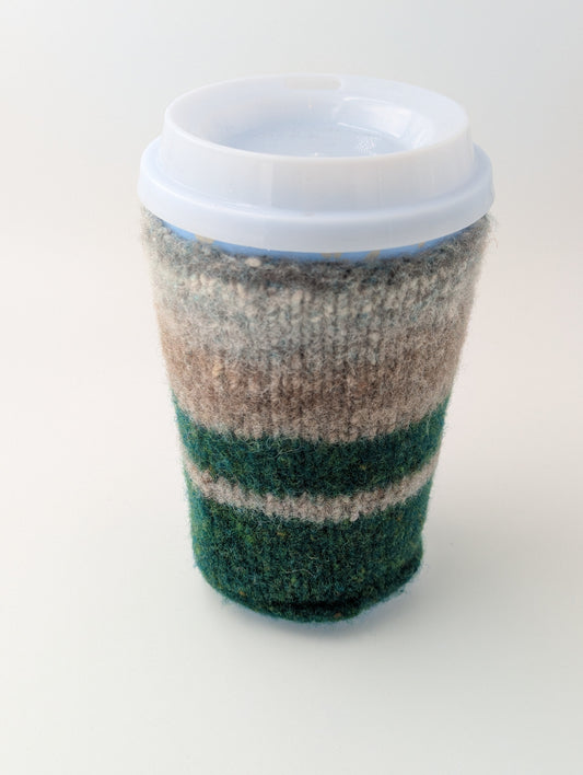 Knitted and felted mug cozy in shades of beige, grey, and green
