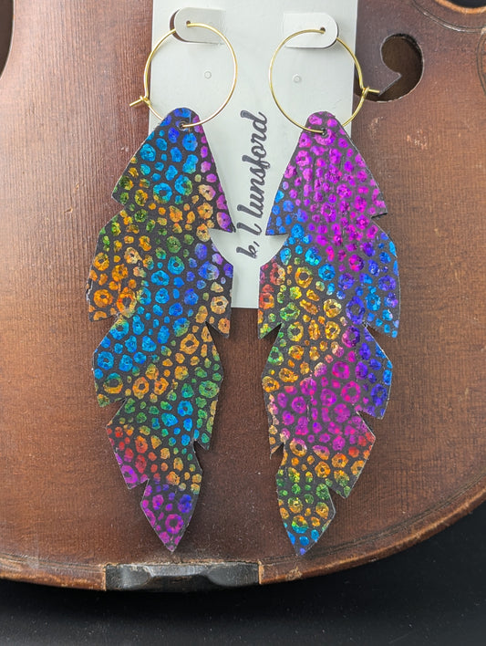 Colorful, feather shaped leather earrings with gold hoops. 5 inches long.