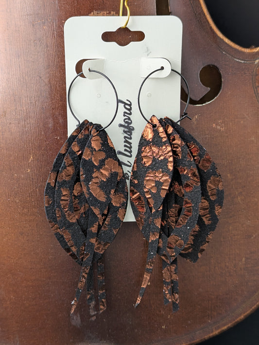 Leather earrings. Black and copper drop and strand shapes with black hoops. 4.5 inches long.