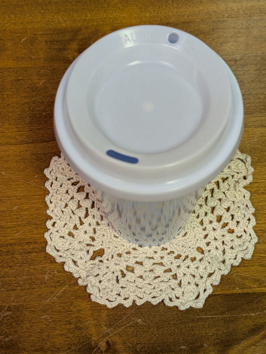 Hand crocheted coaster with mug as an example
