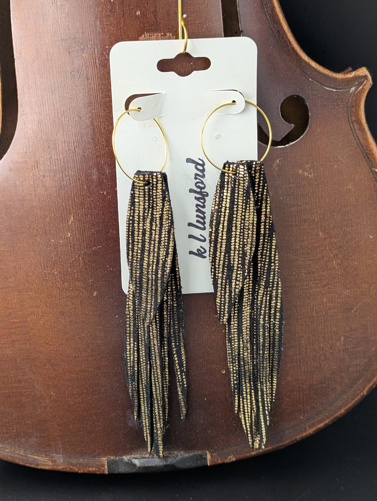 Leather earrings. Segmented drops, gold on black leather with gold hoops. 5 inches long.