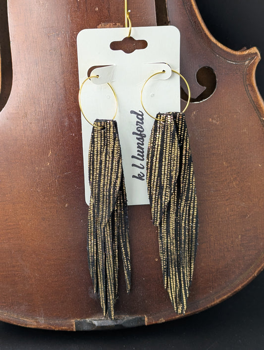 Leather earrings. Segmented drops, gold on black leather with gold hoops. 5 inches long.
