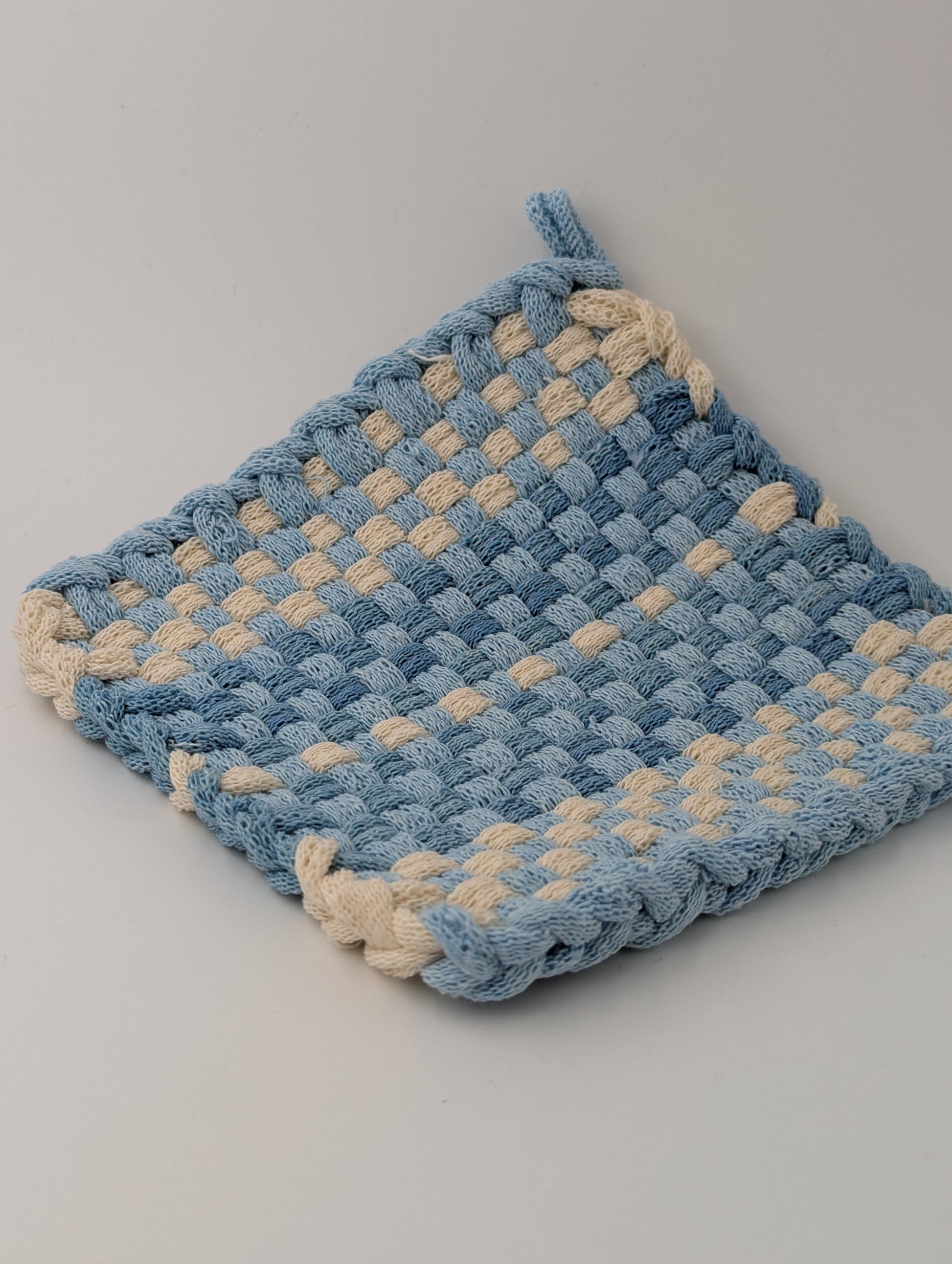 Hand woven pot holder in shades of blue and cream