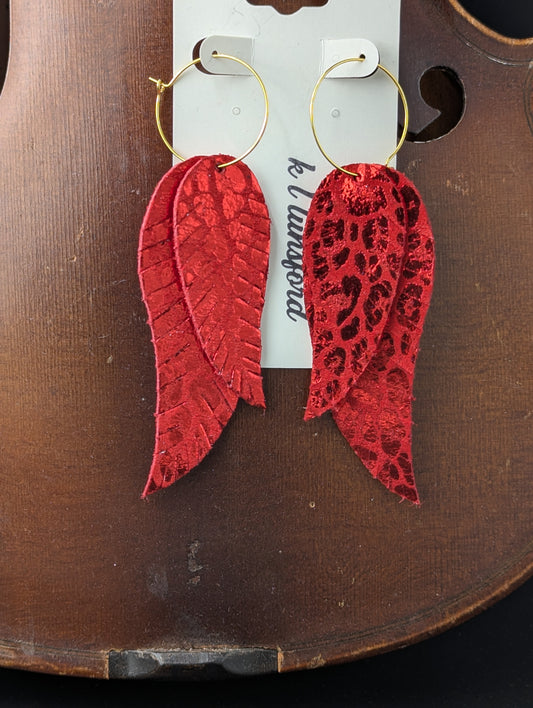 Leather earrings. Feather shaped metallic red on red with gold hoops. 4 inches long.