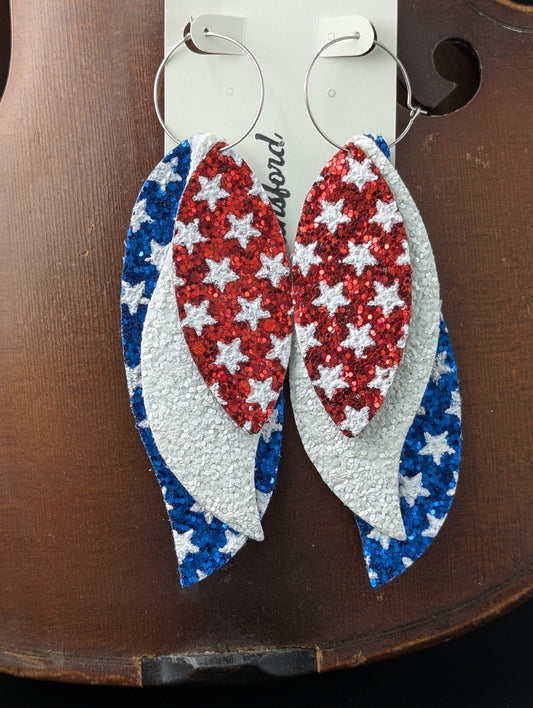 Leather earrings. Red, white and blue sparkles with stars on silver hoop earrings. 4.5 inches in length