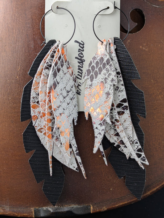 Vegan leather leaf-shaped earrings. Black, white and bronze with black hoops. 5 inches long.
