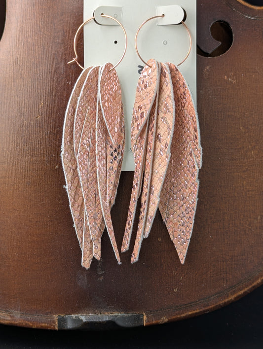 Vegan leather earrings. Feather shaped, pink, with rose gold hoops. 4.5 inches long.