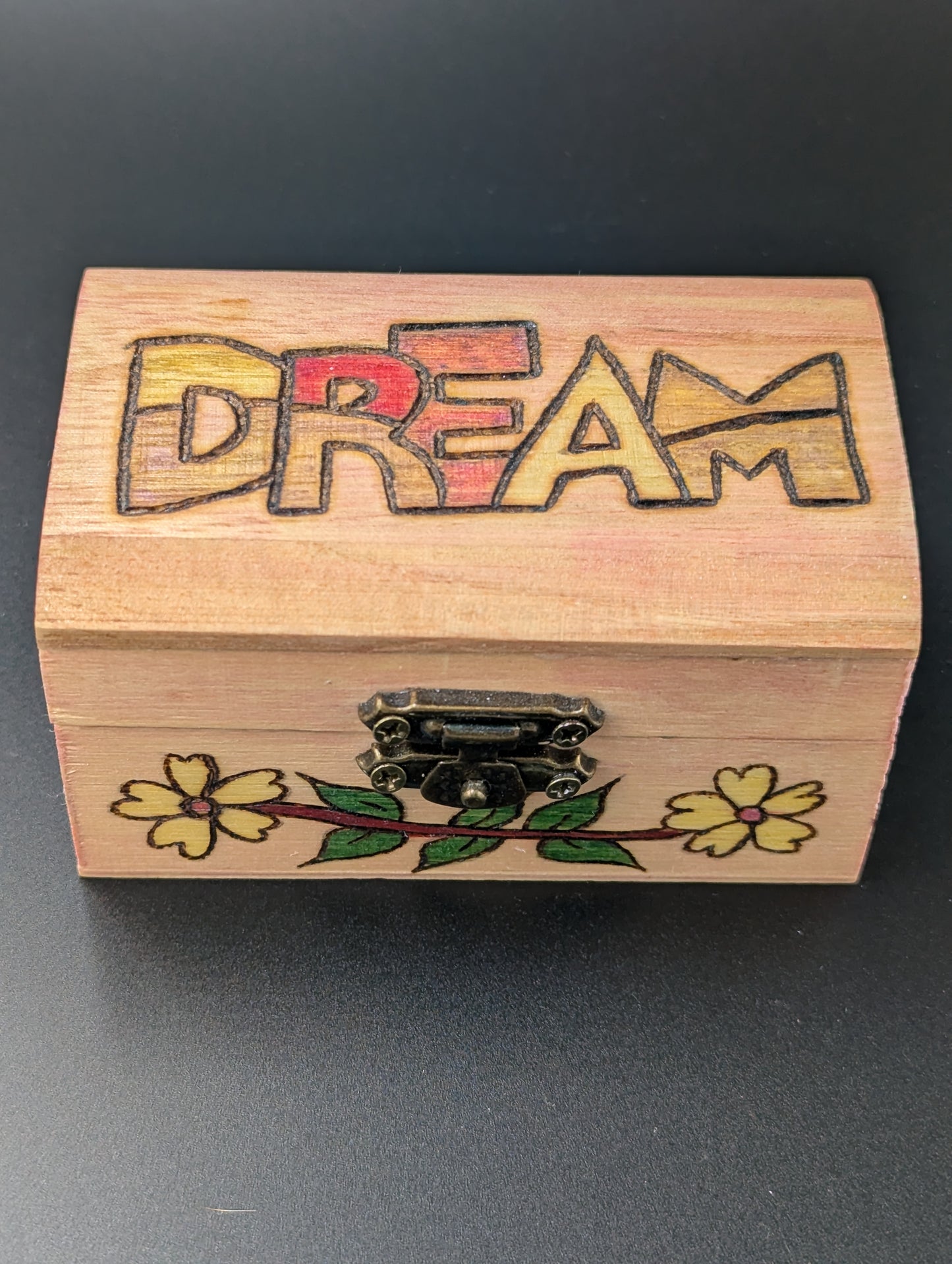 Wooden box with 'DREAM' engraving and floral designs