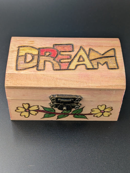 Wooden box with 'DREAM' engraving and floral designs