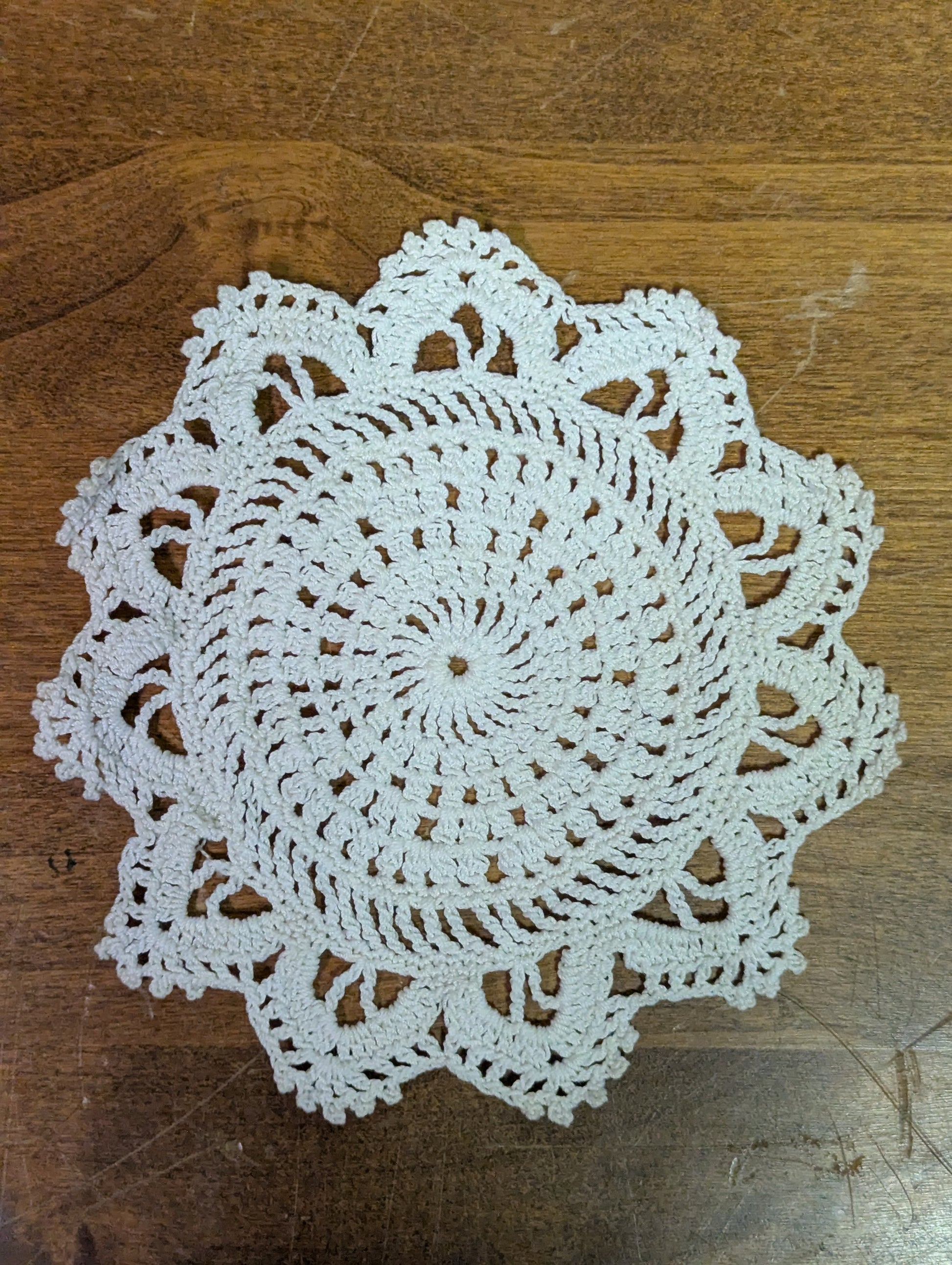 Crochet coaster with a fun flower style motif