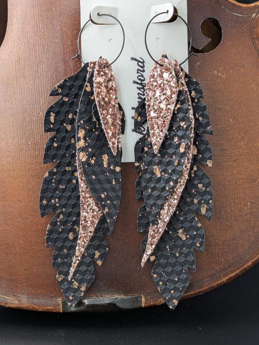 Vegan leather earrings. Black and sparkly bronze on black hoops. 6 inches long.