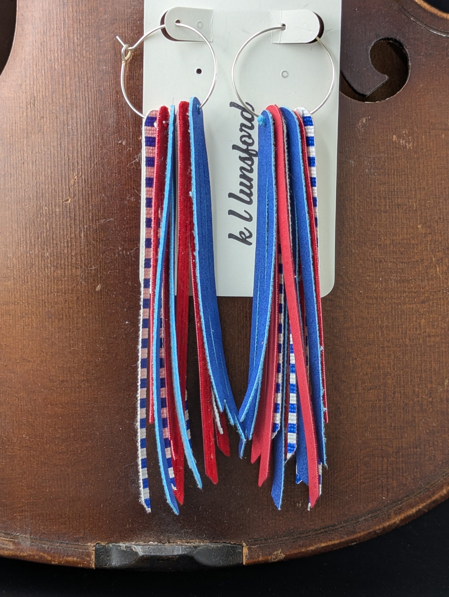 Leather earrings on silver hoops. Red, white, and blue with stripes. 5 inches in length