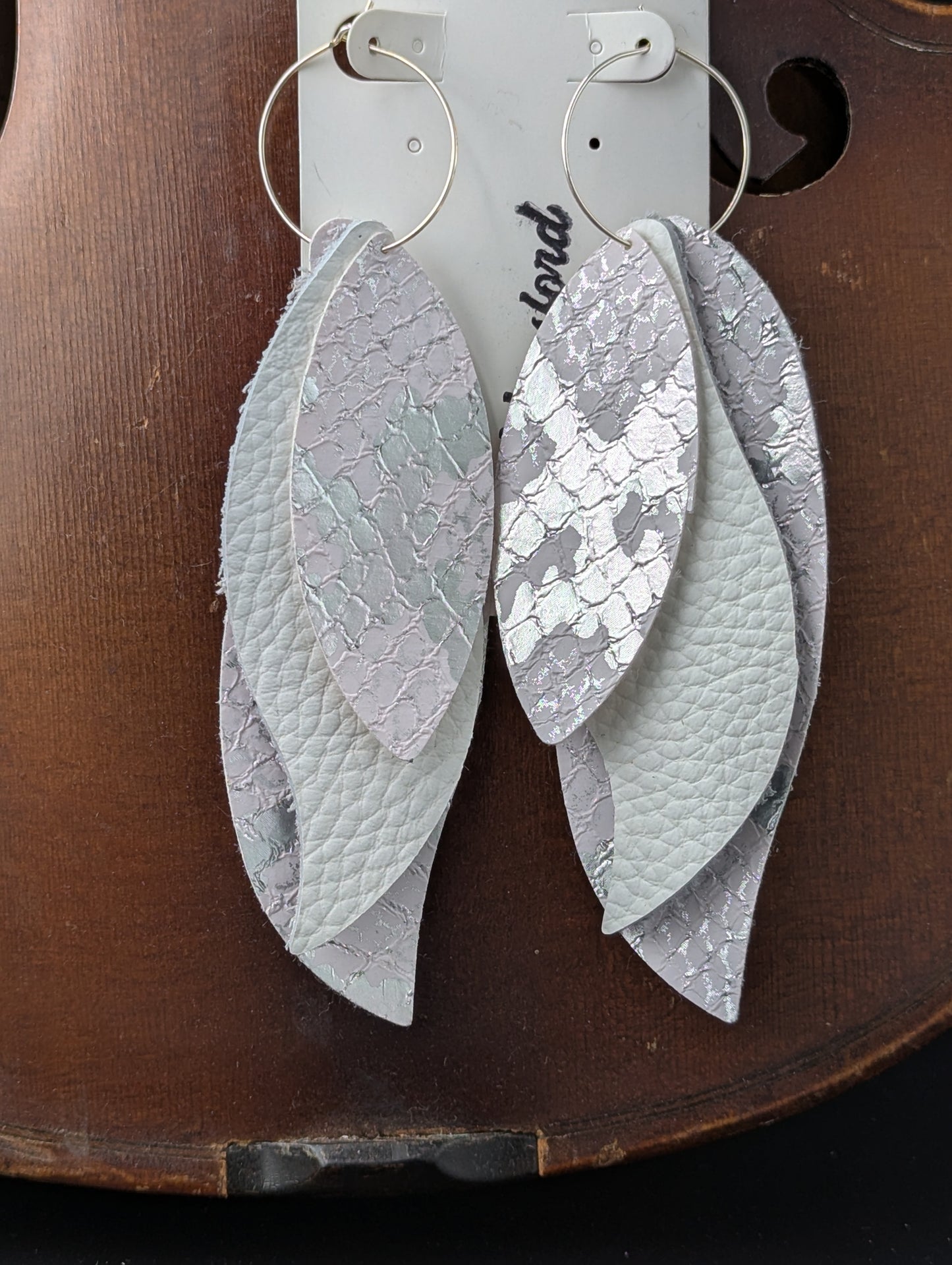 Vegan leather earrings. Leaf shaped white and silver with silver hoops. 4.5 inches long