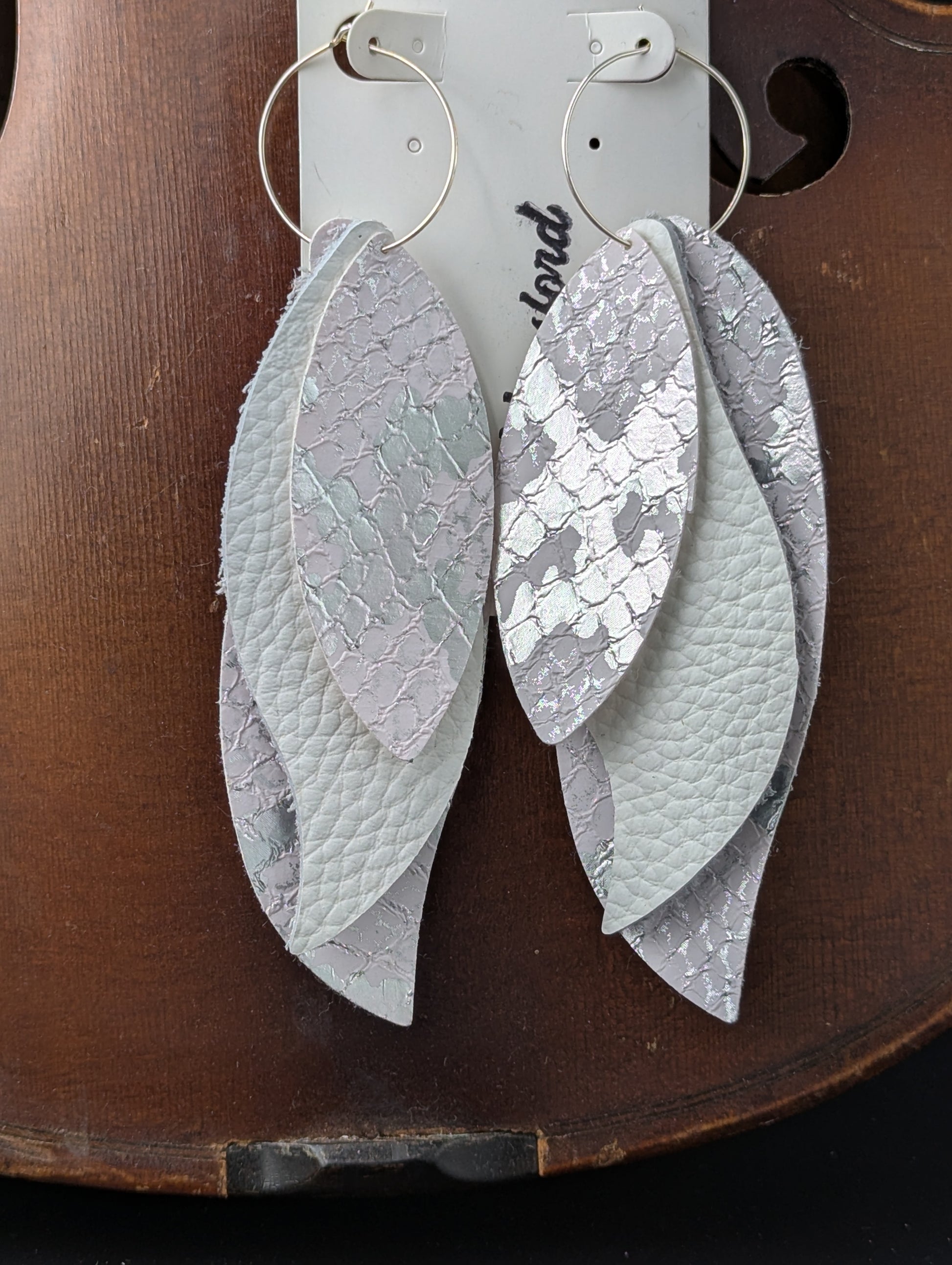 Vegan leather earrings. Leaf shaped white and silver with silver hoops. 4.5 inches long