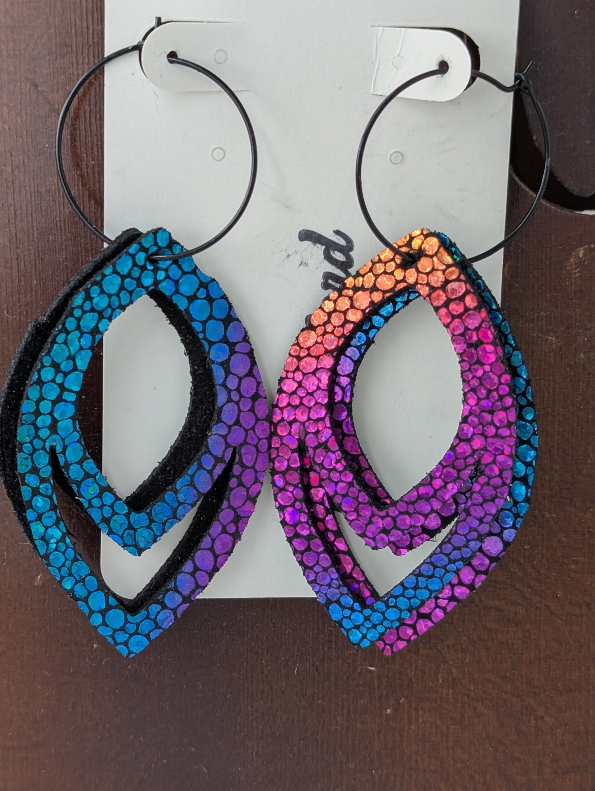 Drop shaped iridescent and black leather earrings on black hoops. 3 inches long.